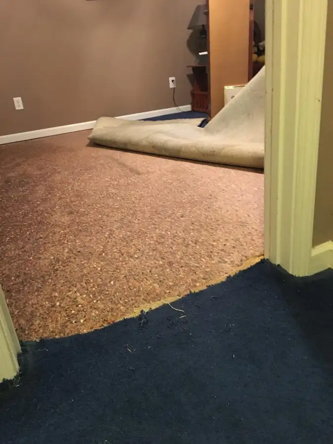 Carpet pad removal revealing water damage during Water Mitigation Services in Gonzales